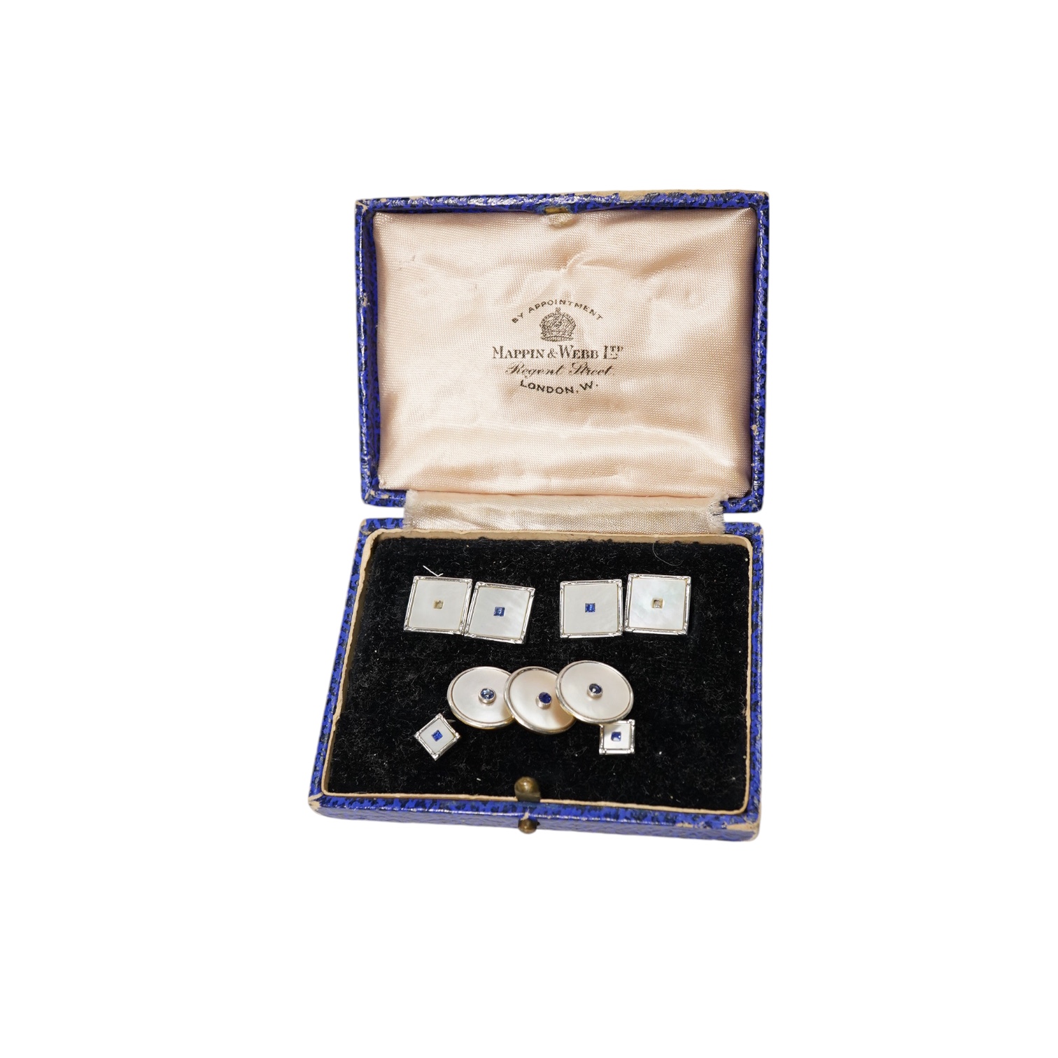 A cased four piece 9ct, mother of pearl and sapphire set dress stud set and three similar 18ct dress studs. Condition - poor to fair